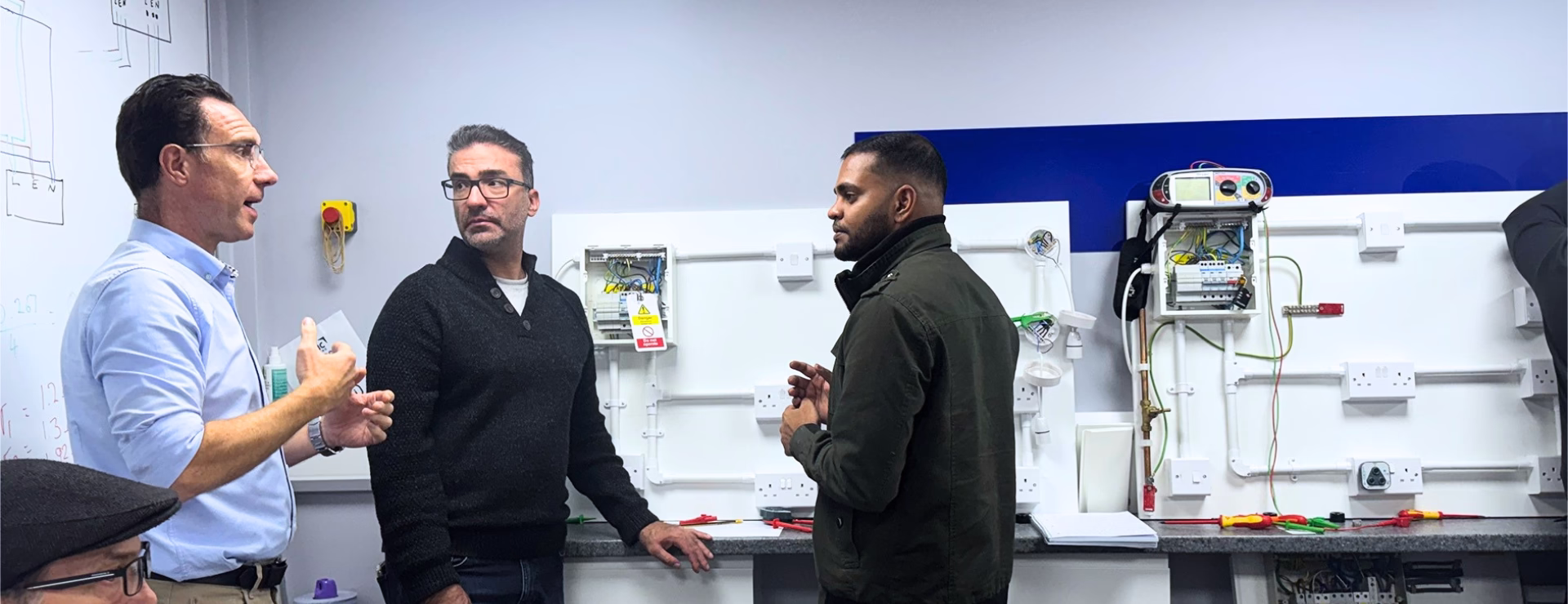 A Logic4training trainer and 2 students in a electrical classroom