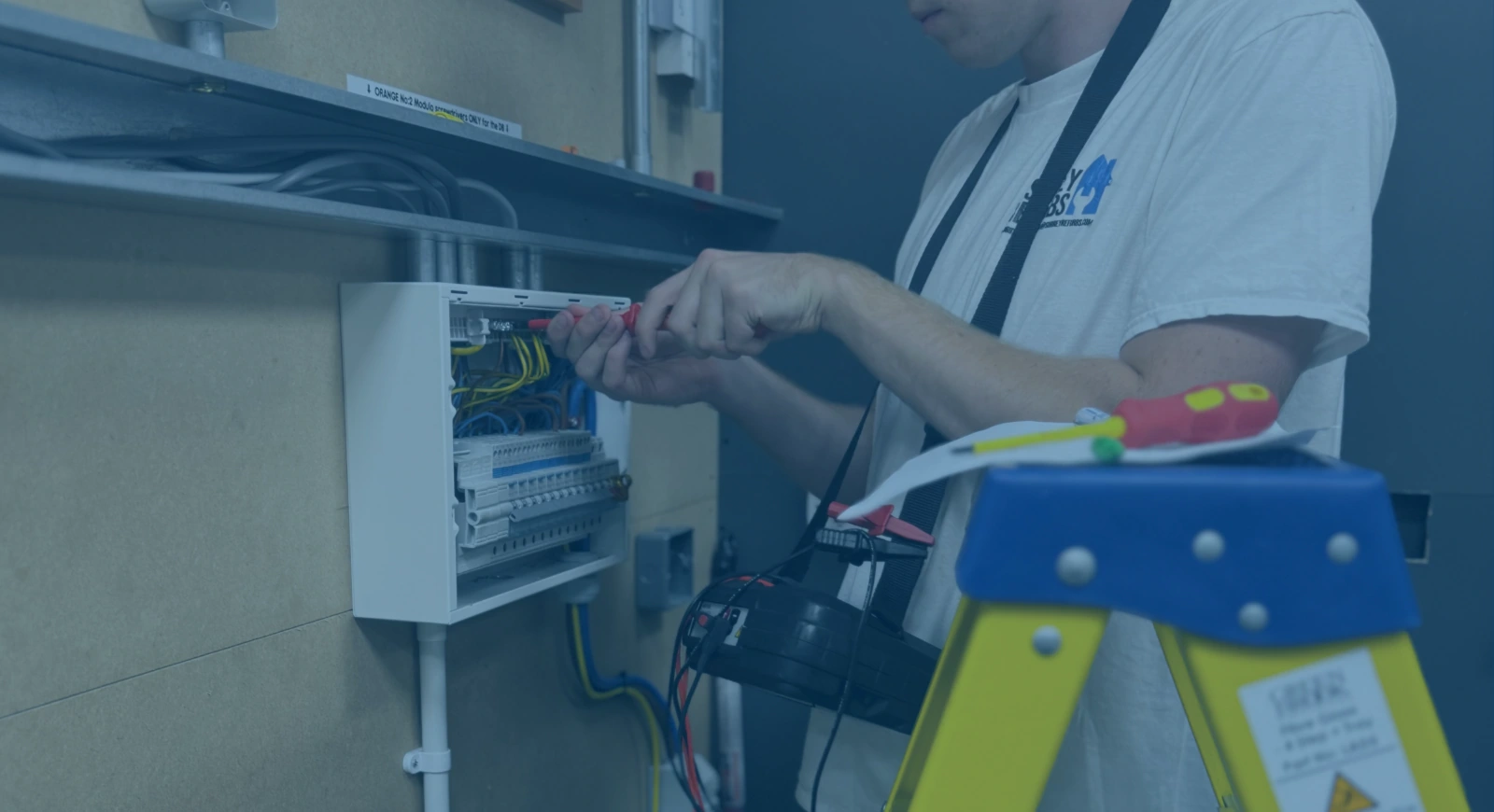 building services trainee working on an electrical box