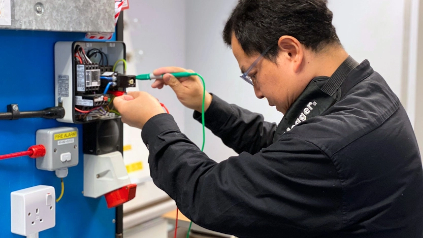 A Logic4training electrical student carrying out initial inspection and testing during their electrical inspection & testing course