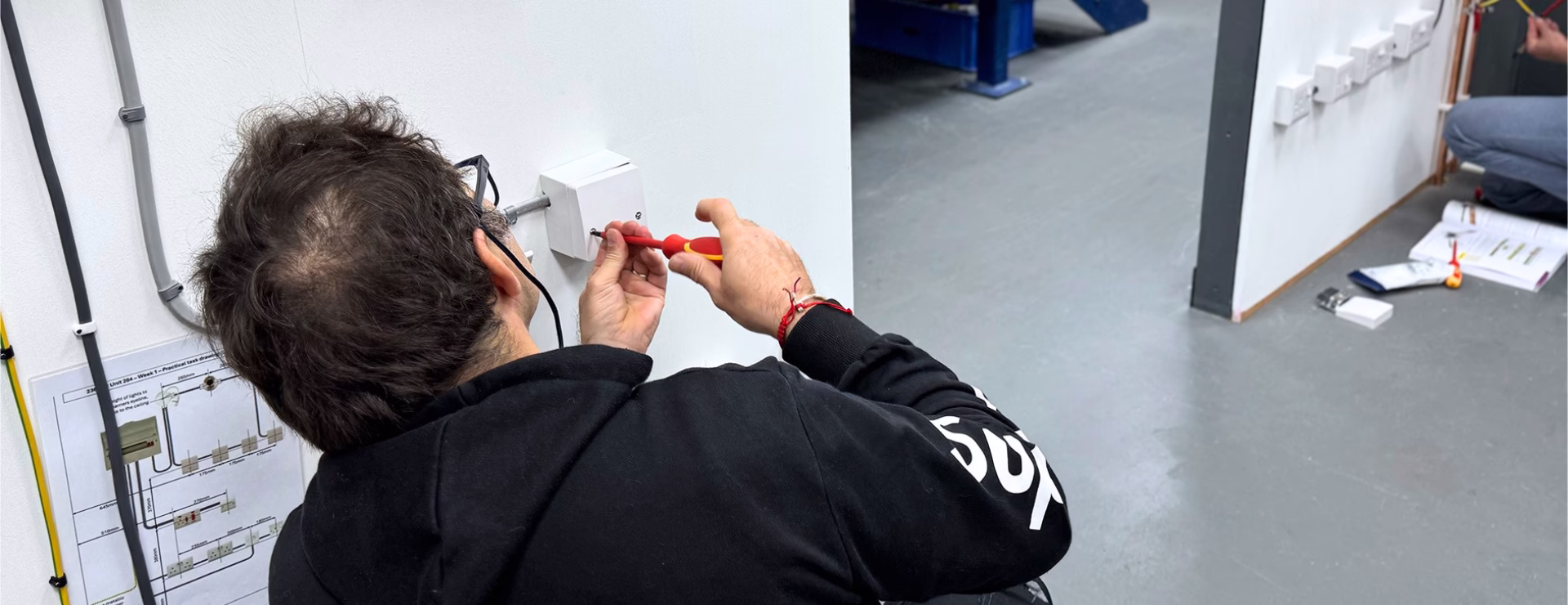 A Logic4training electrical student working on a wiring circuit