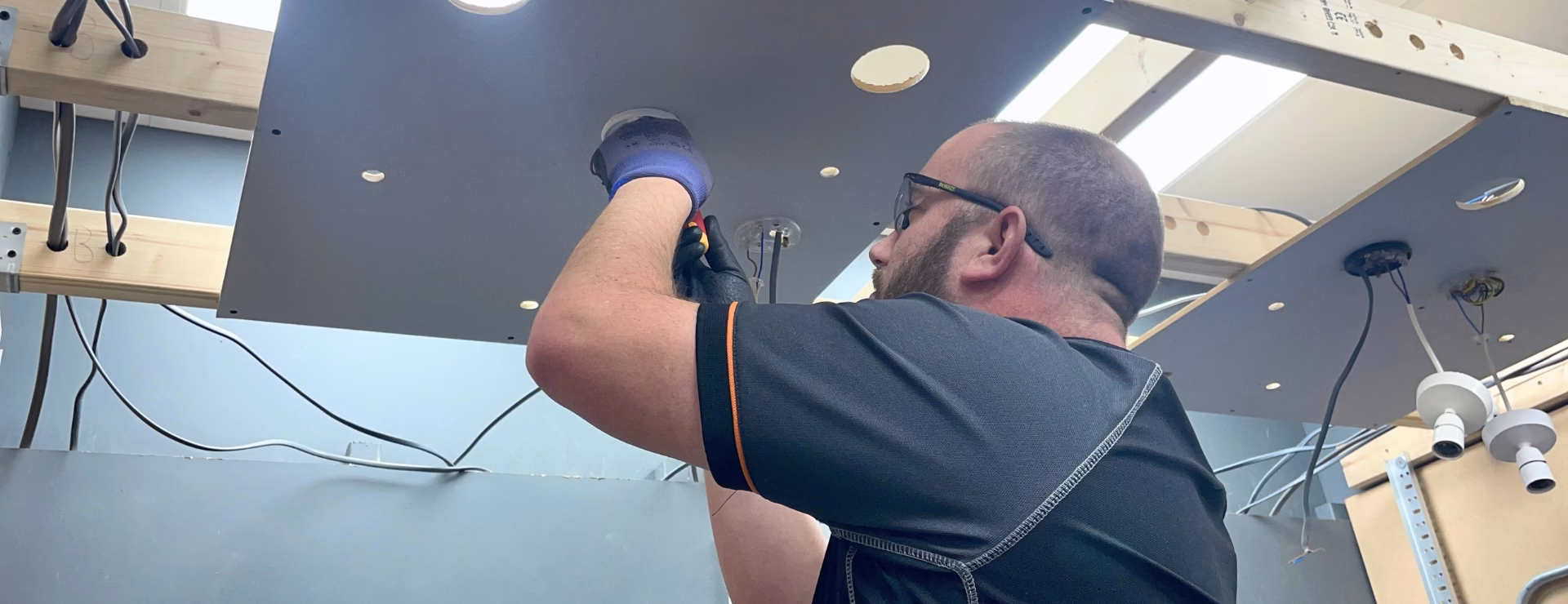A Logic4training electrical trainee wiring a light