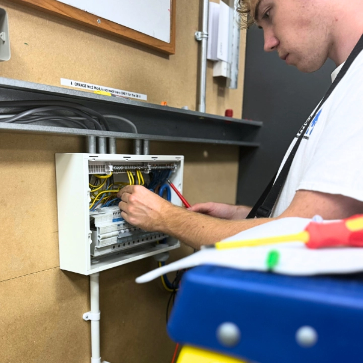 A Logic4training selectrical student working on consumer unit as part of their electrical course