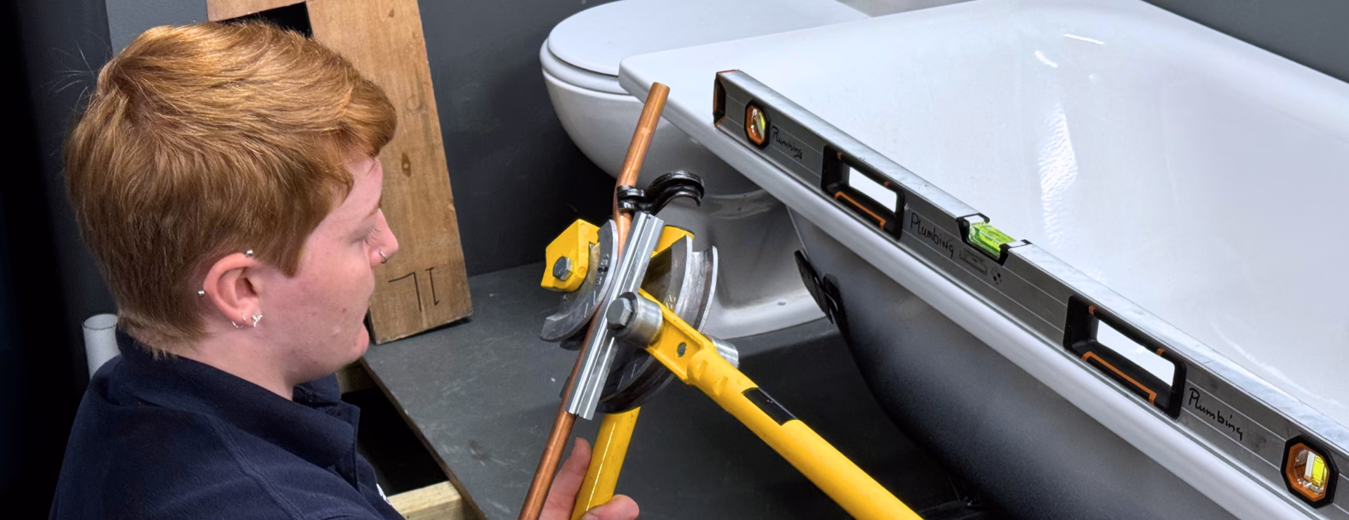 A Logic4training Plumber completing a bathroom install