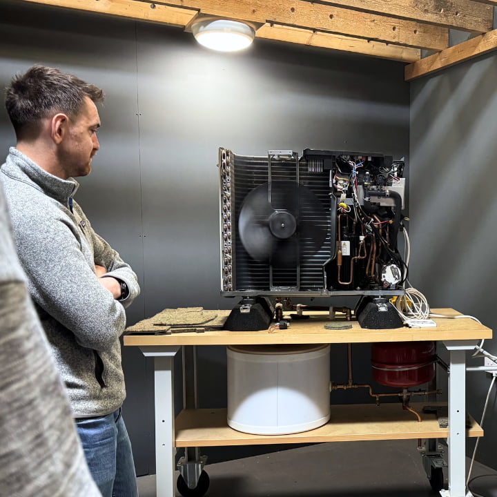 A Logic4training heat pump candidate looking at an open air source heat pump