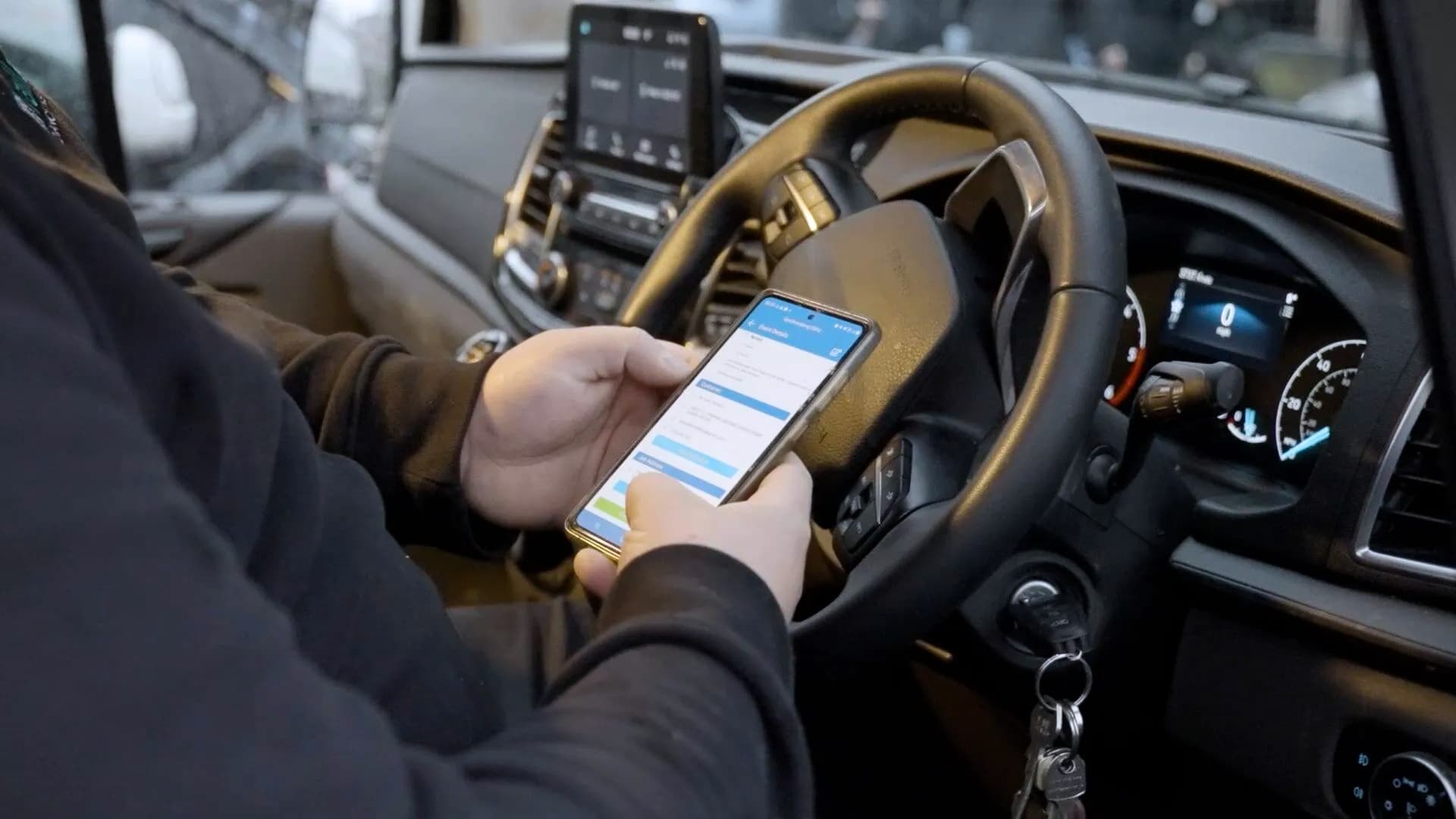 A gas engineer using the Gas Engineer Software in their van