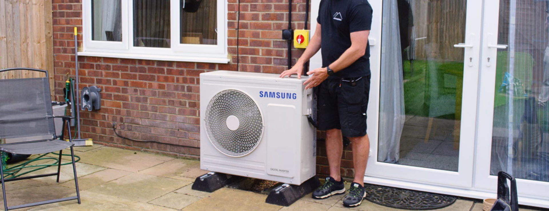 A Alto Energy heat pump installer fitting a heat pump