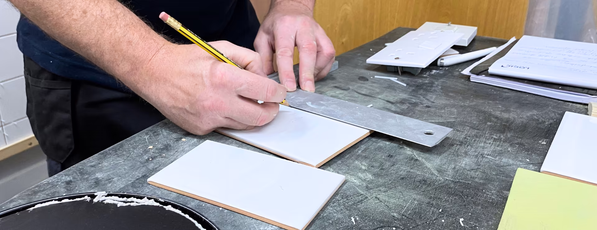 A Logic4training candidate preparing tiles to tile a wall