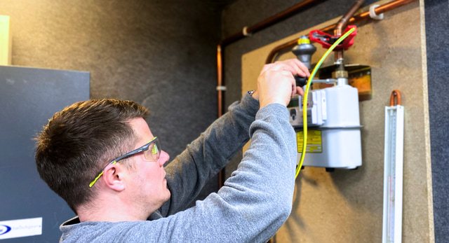 A dual fuel smart meter candidate learning how to work on a gas meter