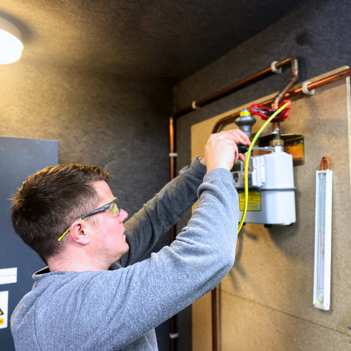 A dual fuel smart meter candidate learning how to work on a gas meter