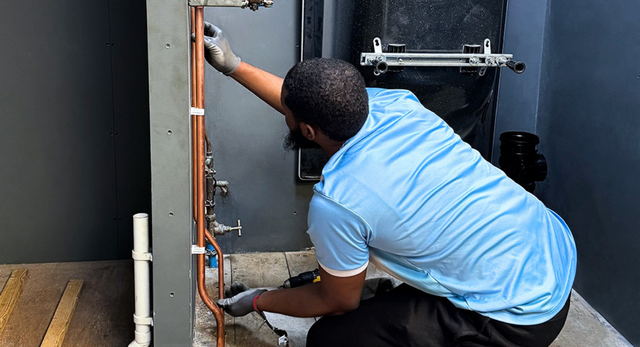A man completing his plumbing training to become a plumber