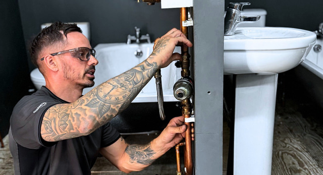 A plumbing and heating student working on a mag clean
