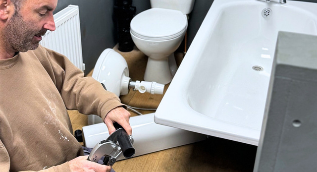A trainee plumber completing a plumbing course near London