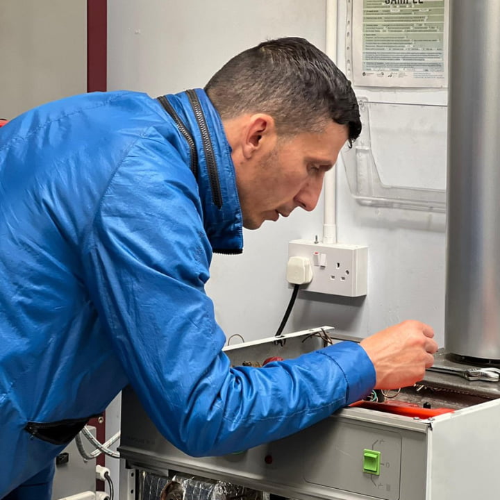A Logic4training oil candidate working on an oil boiler