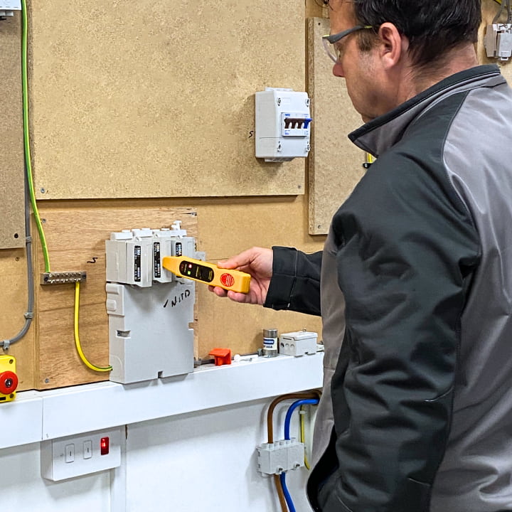 Smart meter engineer completing a safety test as part of the renewal training