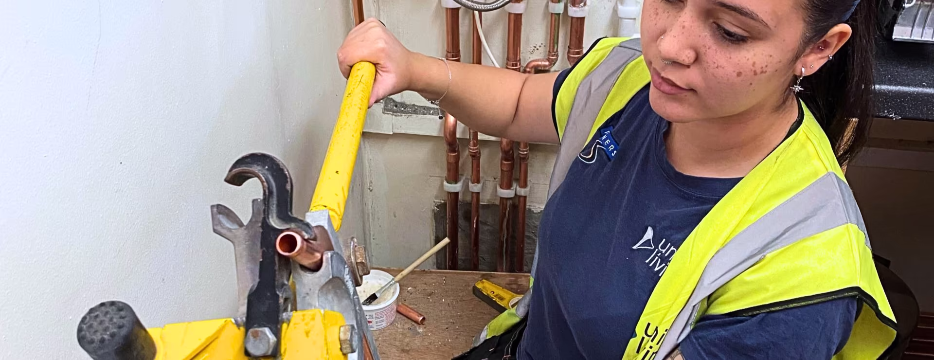 A female plumber working inline with G3 regulations