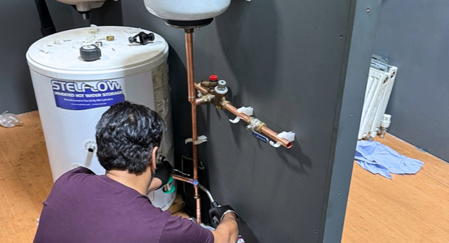 A trainee plumber working to G3 regulations