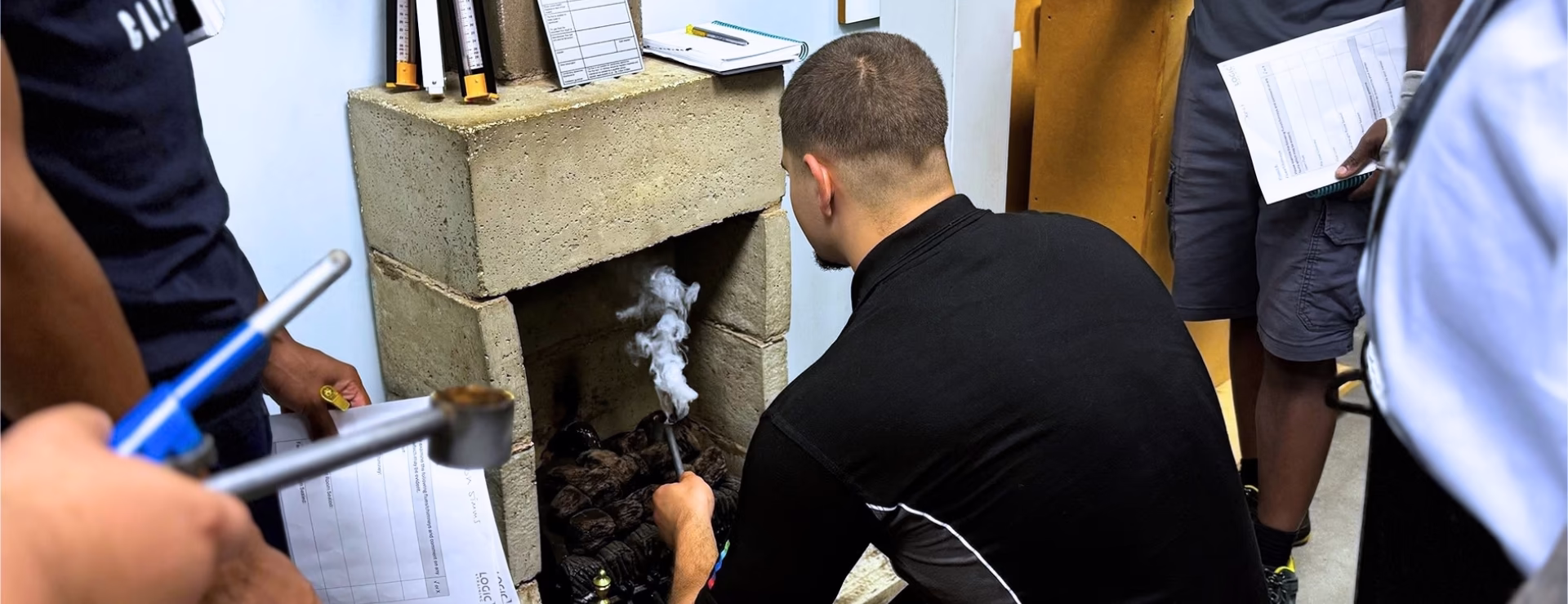 A gas apprentice learning how to correctly carry out a flue flow test