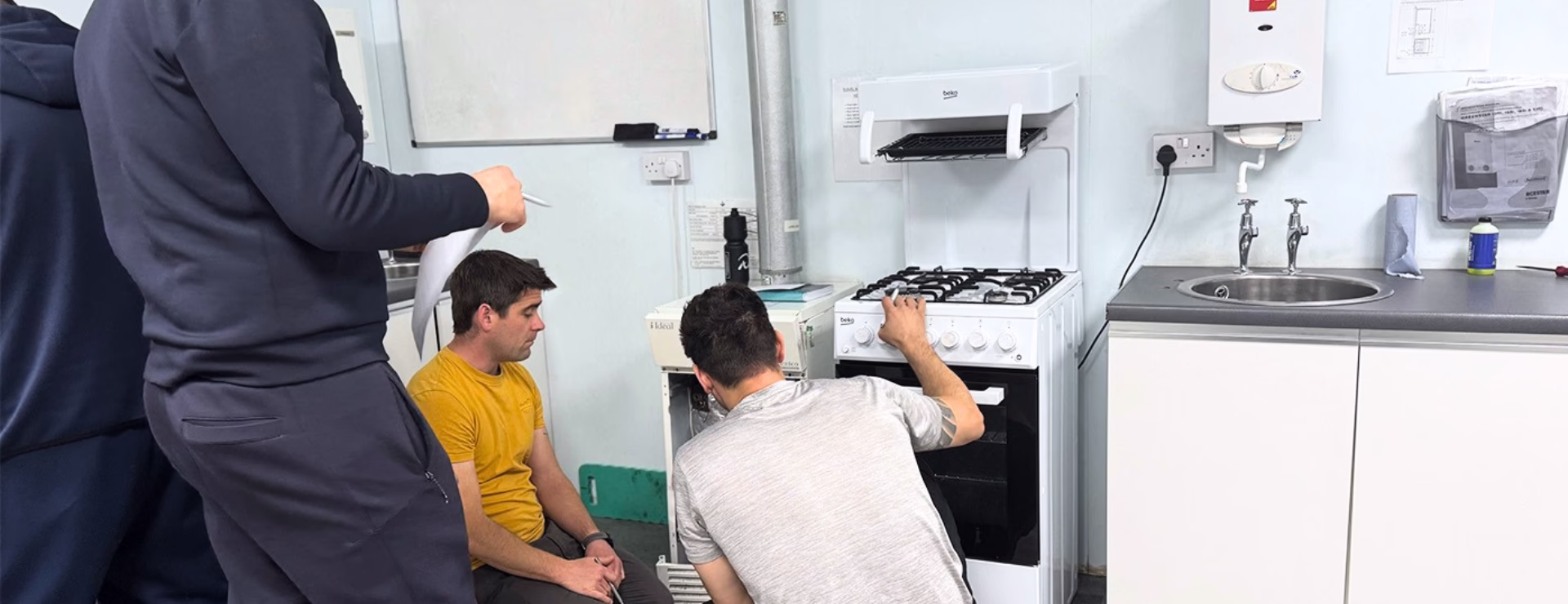 A group of trainee gas engineers working on gas appliances