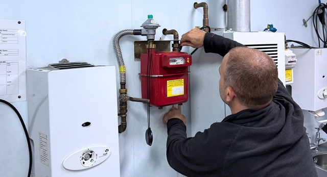 A man working on a domestic gas meter as part of their training to complete their ACS Gas Assessments with Logic4training