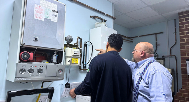 Gas apprentice and trainer going through a tightness test