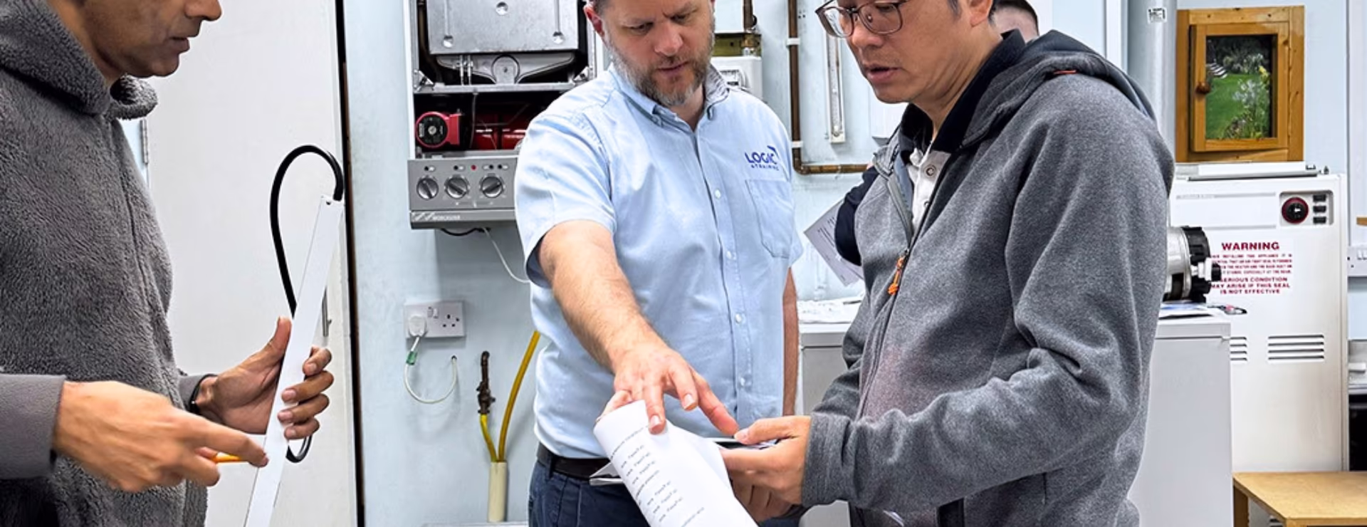 Plumber and a gas trainer going through gas regulations